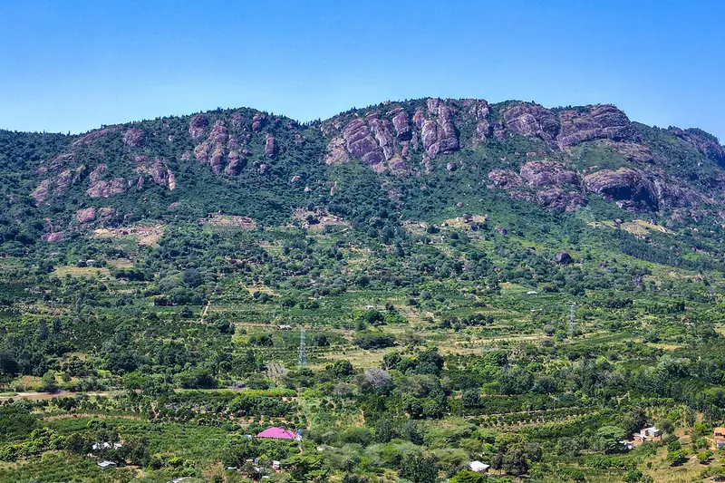Rocky Makueni hills rising above green farms and scattered homes.