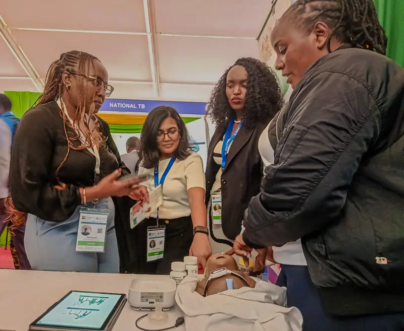 Health summit visitors viewing a newborn care demonstration at Makueni’s exhibition booth in Nairobi.