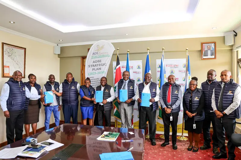 Governor Mutula and partner representatives displaying cooperation agreements at the signing in Wote.